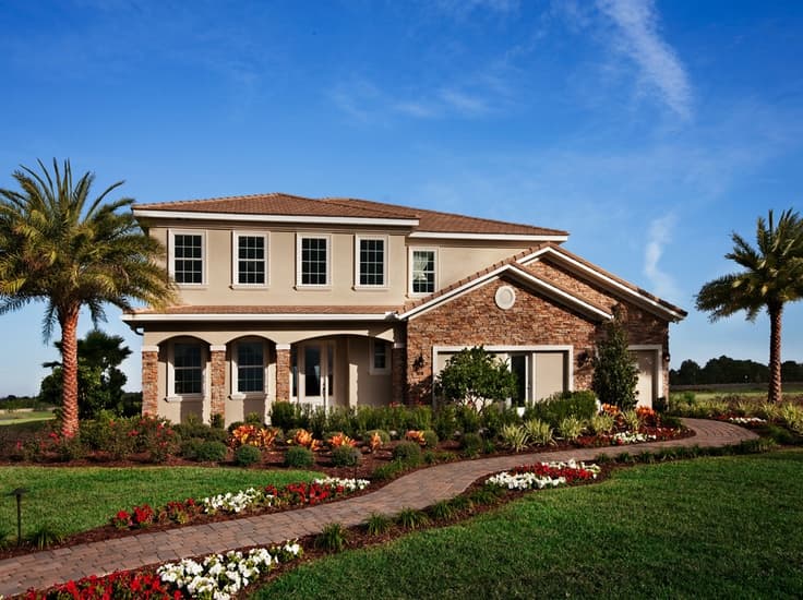 Aerial view of a custom Florida home under construction surrounded by palm trees