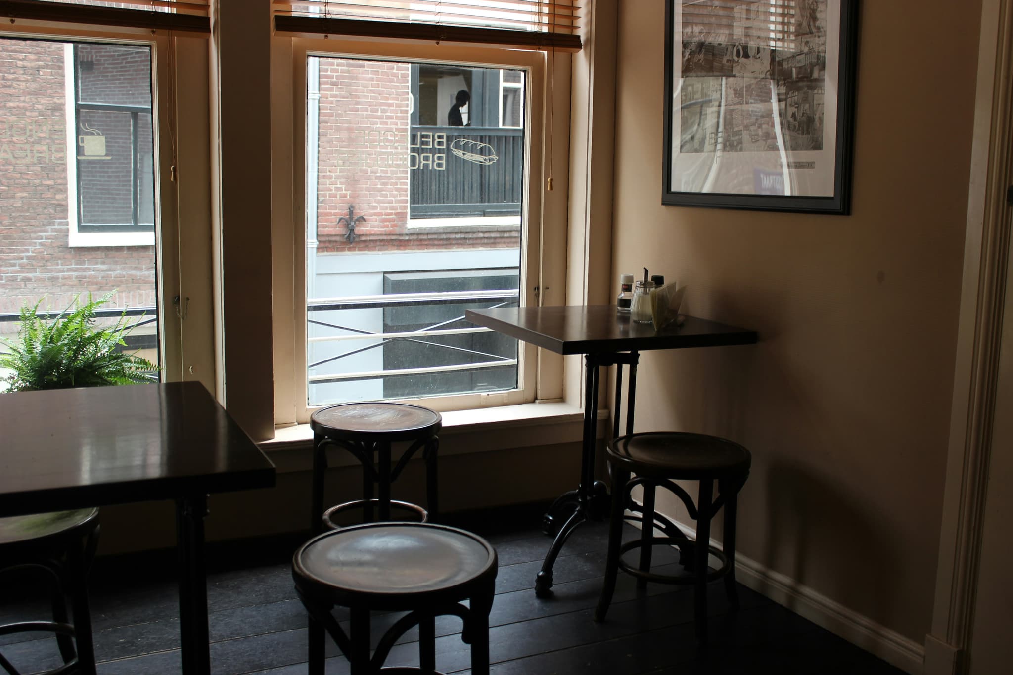 Bar seating area with stools and pass-through window